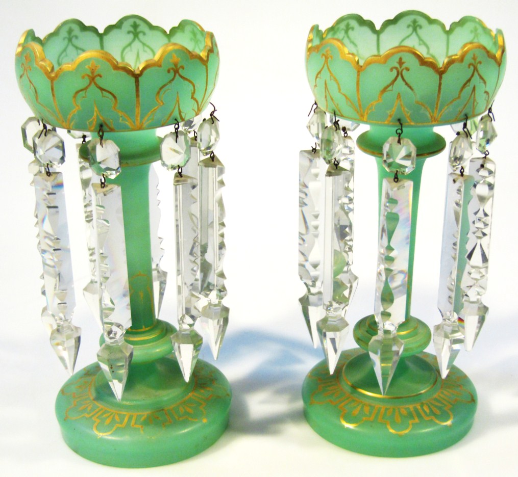 Appraisal: A pair of Victorian green glass lustres each castellated top