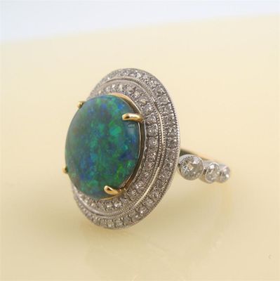 Appraisal: A opal and diamond cluster ring The slightly oval shaped