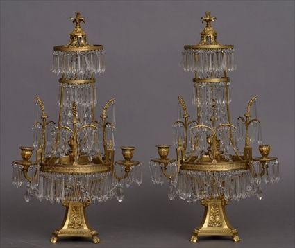 Appraisal: PAIR OF EMPIRE-STYLE CUT-GLASS MOUNTED GILT-BRONZE THREE-LIGHT CANDELABRA Each flared