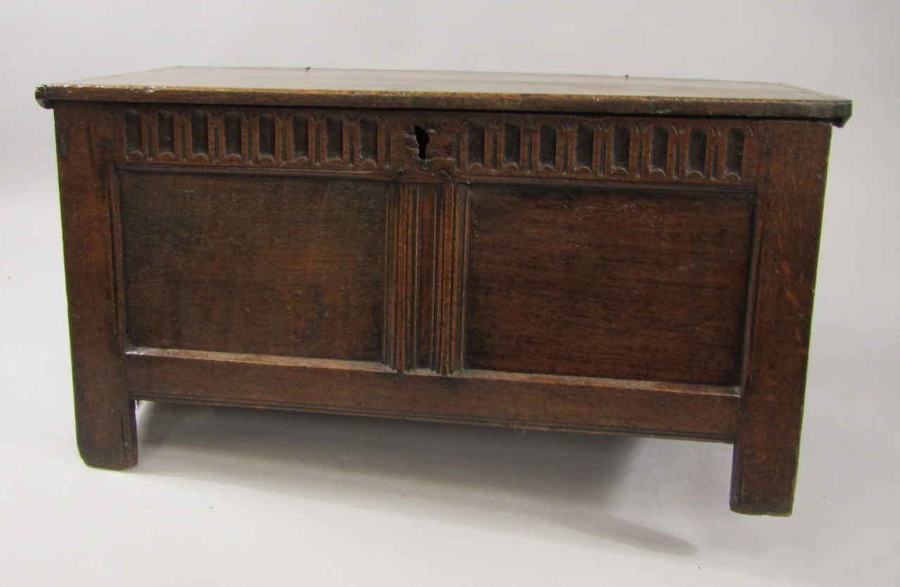 Appraisal: A thC oak coffer with a carved panel front raised