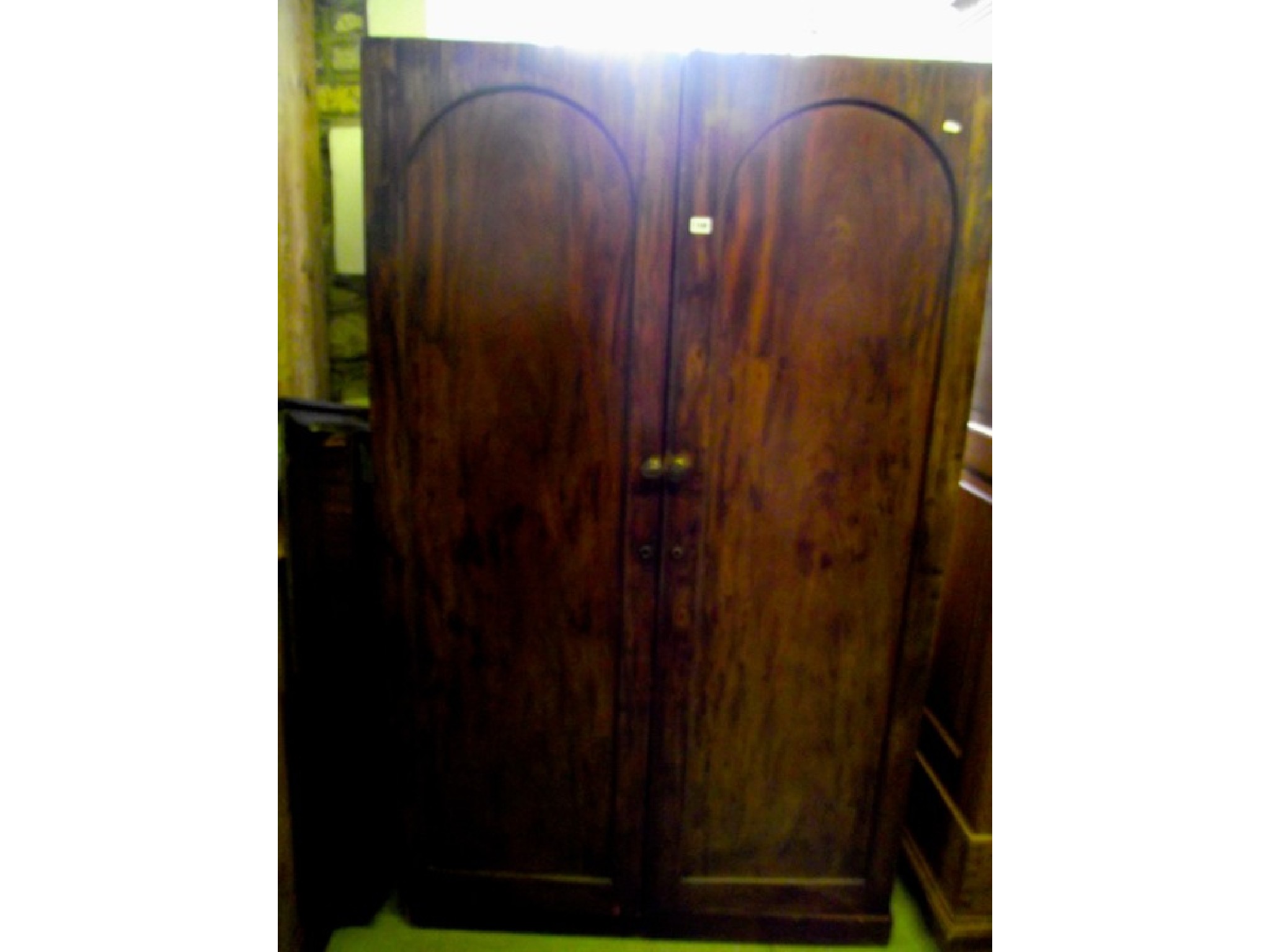 Appraisal: A th century mahogany wardrobe enclosed by a pair of