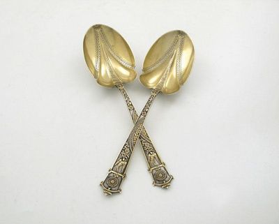 Appraisal: A pair of Victorian parcel-gilt Aesthetic Movement fruit serving spoons