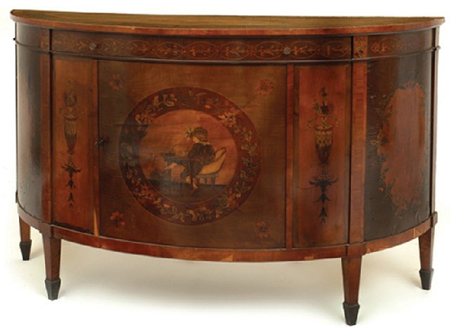 Appraisal: A CONTINENTAL FRUITWOOD AND MARQUETRY COMMODE The demilune top ornately