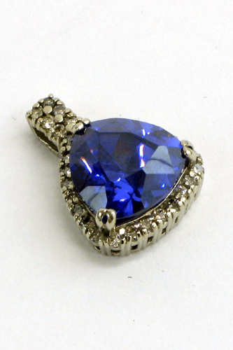 Appraisal: TANZANITE AND FOURTEEN KARAT WHITE GOLD PENDANT in length and