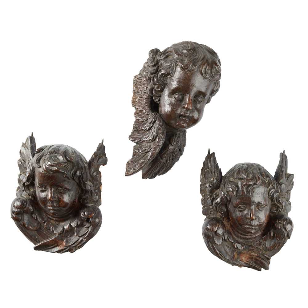 Appraisal: THREE CHERUBIM MASK CARVINGS TH EARLY TH CENTURY to include