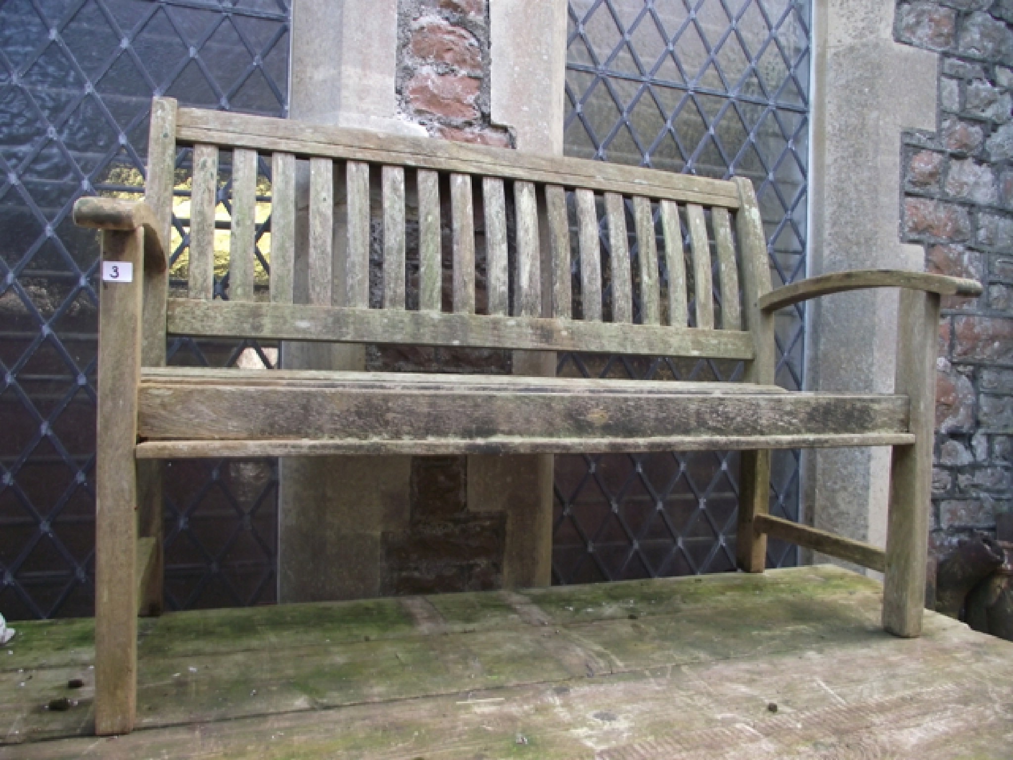 Appraisal: A weathered contemporary hardwood garden bench with slatted seat back