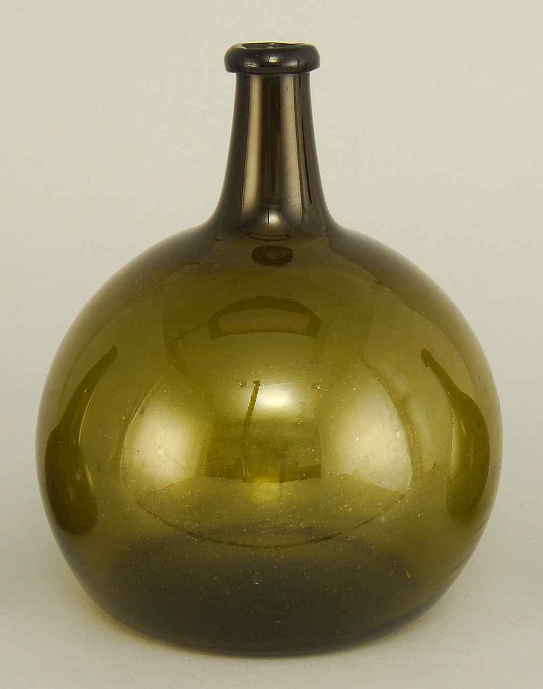 Appraisal: ANTIQUE DARK GREEN BLOWN GLASS BOTTLE th CenturyWith rolled rim