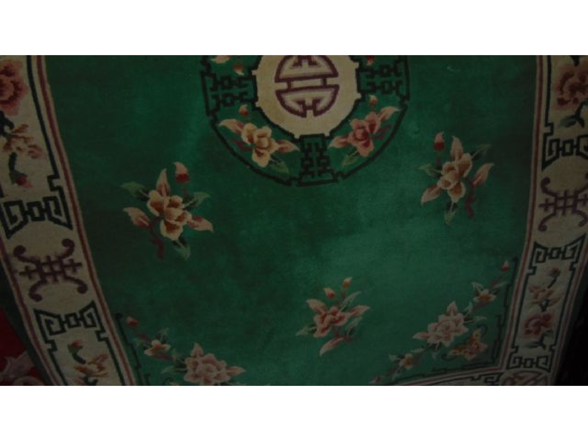 Appraisal: A Chinese green ground wool carpet with central medallion further