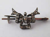 Appraisal: A plated metal tests gold rose cut diamond bow brooch