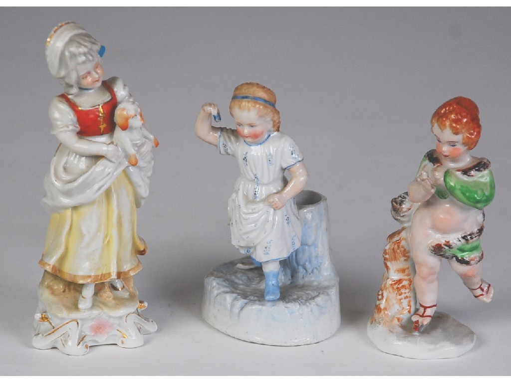 Appraisal: THREE CONTINENTAL PORCELAIN FIGURE comprising ONE MODELLED AS A PUTTO