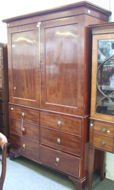 Appraisal: An early th century mahogany linen press the plain cornice