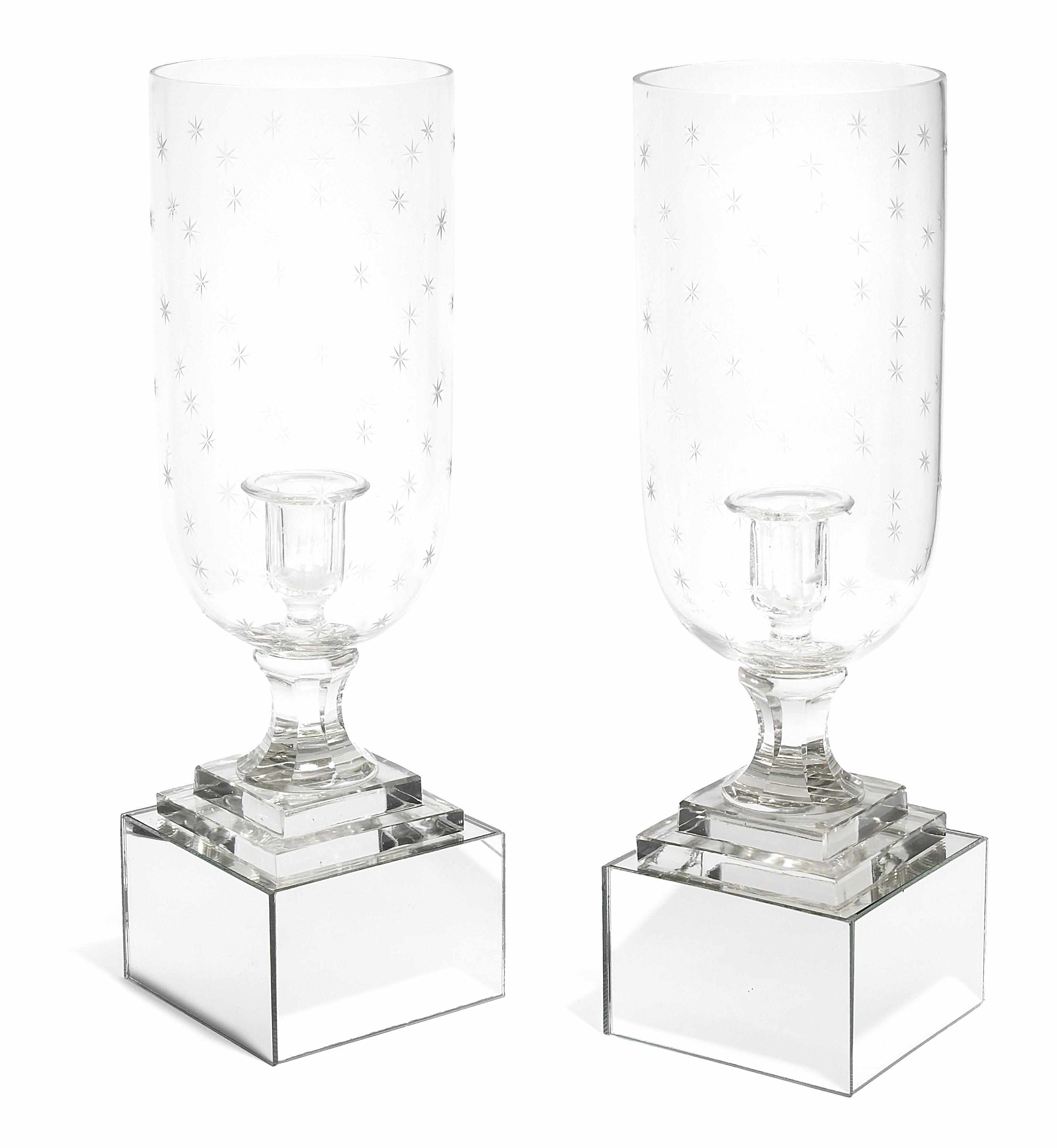 Appraisal: A pair of etched glass candlesticks with hurricane shades on