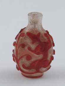 Appraisal: A clear glass Chinese snuff bottle with raised ruby overlay