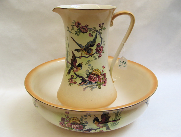 Appraisal: ENGLISH POTTERY BOWL PITCHER with bird and floral decoration on