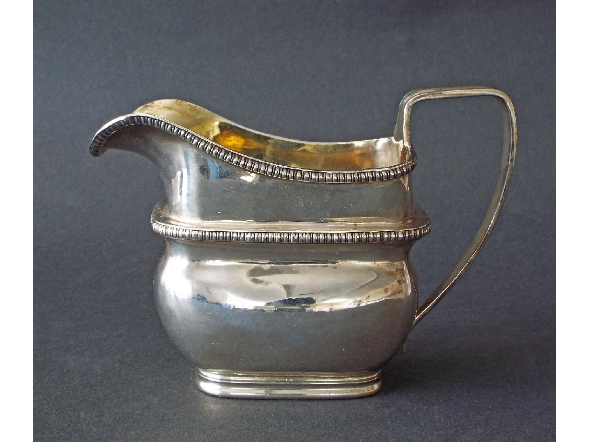 Appraisal: George III silver tall boat shaped cream jug with twin