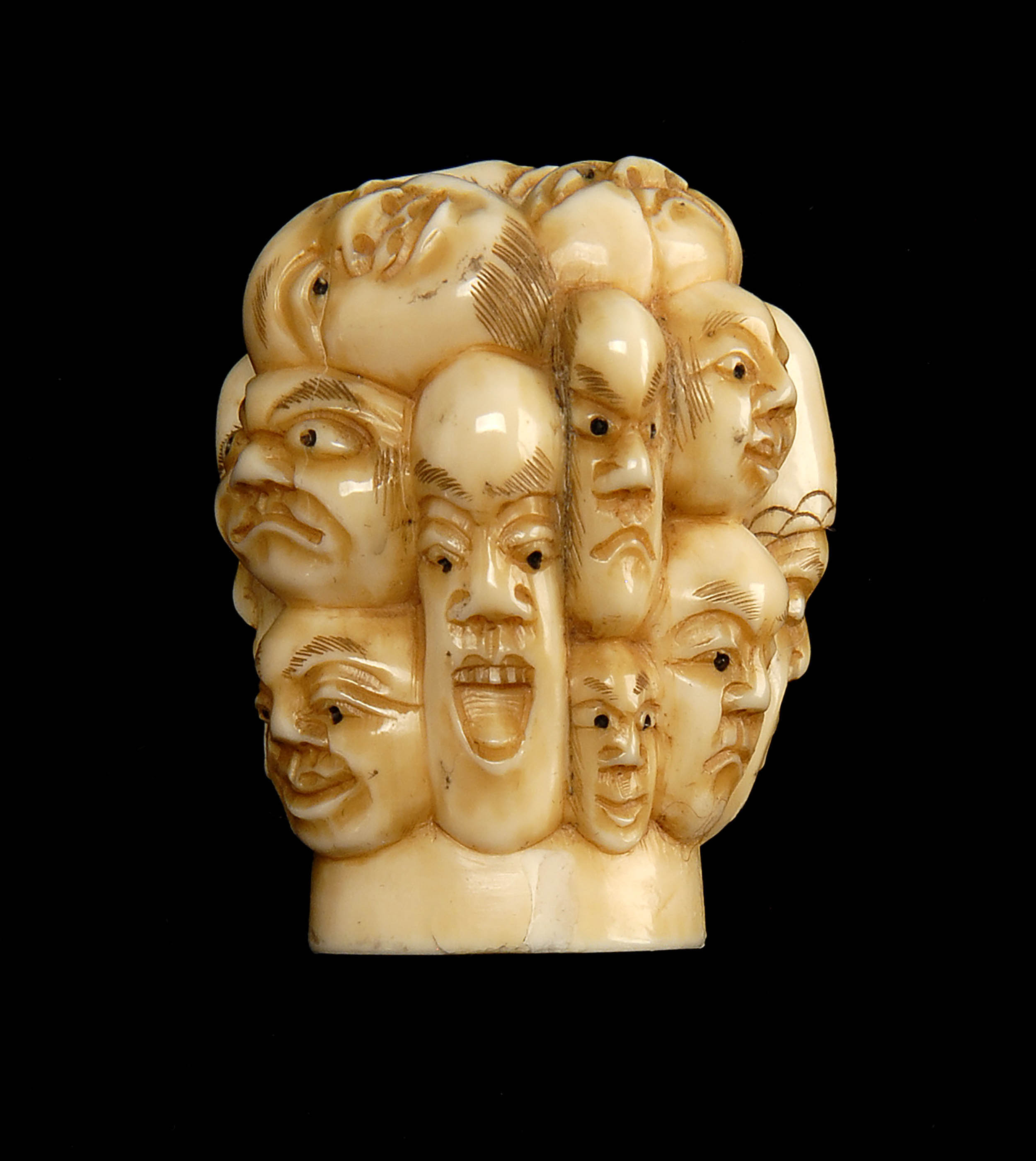 Appraisal: IVORY CANE HANDLE Meiji PeriodCarved with numerous masks Signed Gyokuzan