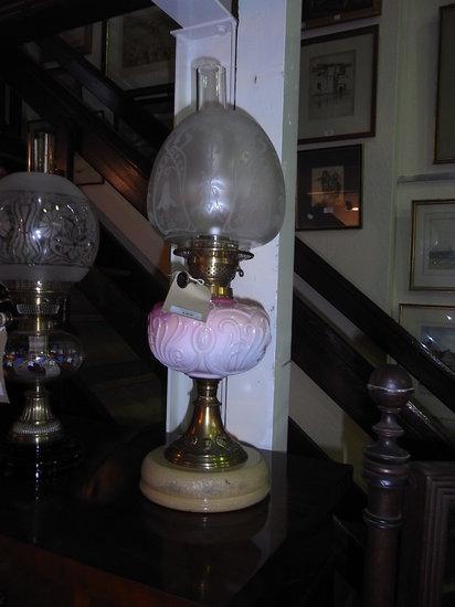 Appraisal: TWO OIL LAMPS each with moulded pink glass reservoirs high