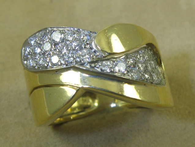 Appraisal: DIAMOND AND FOURTEEN KARAT GOLD RING set with round-cut diamonds