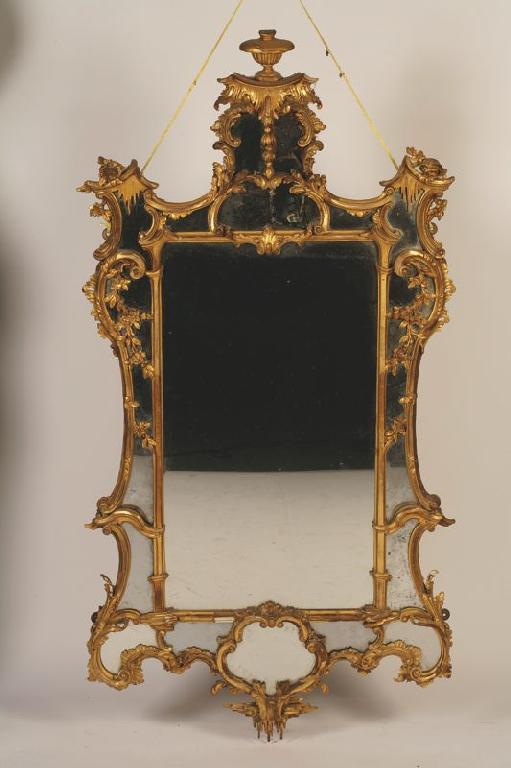 Appraisal: A GEORGE III GILTWOOD WALL MIRROR of rococo design the