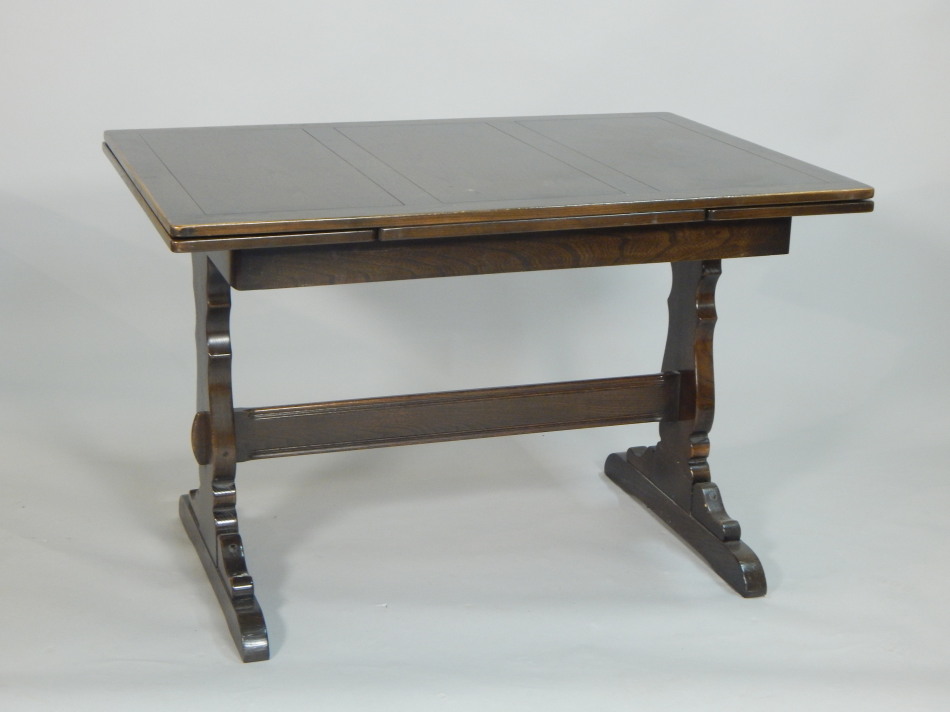 Appraisal: An Ercol oak refectory style dining table on end supports