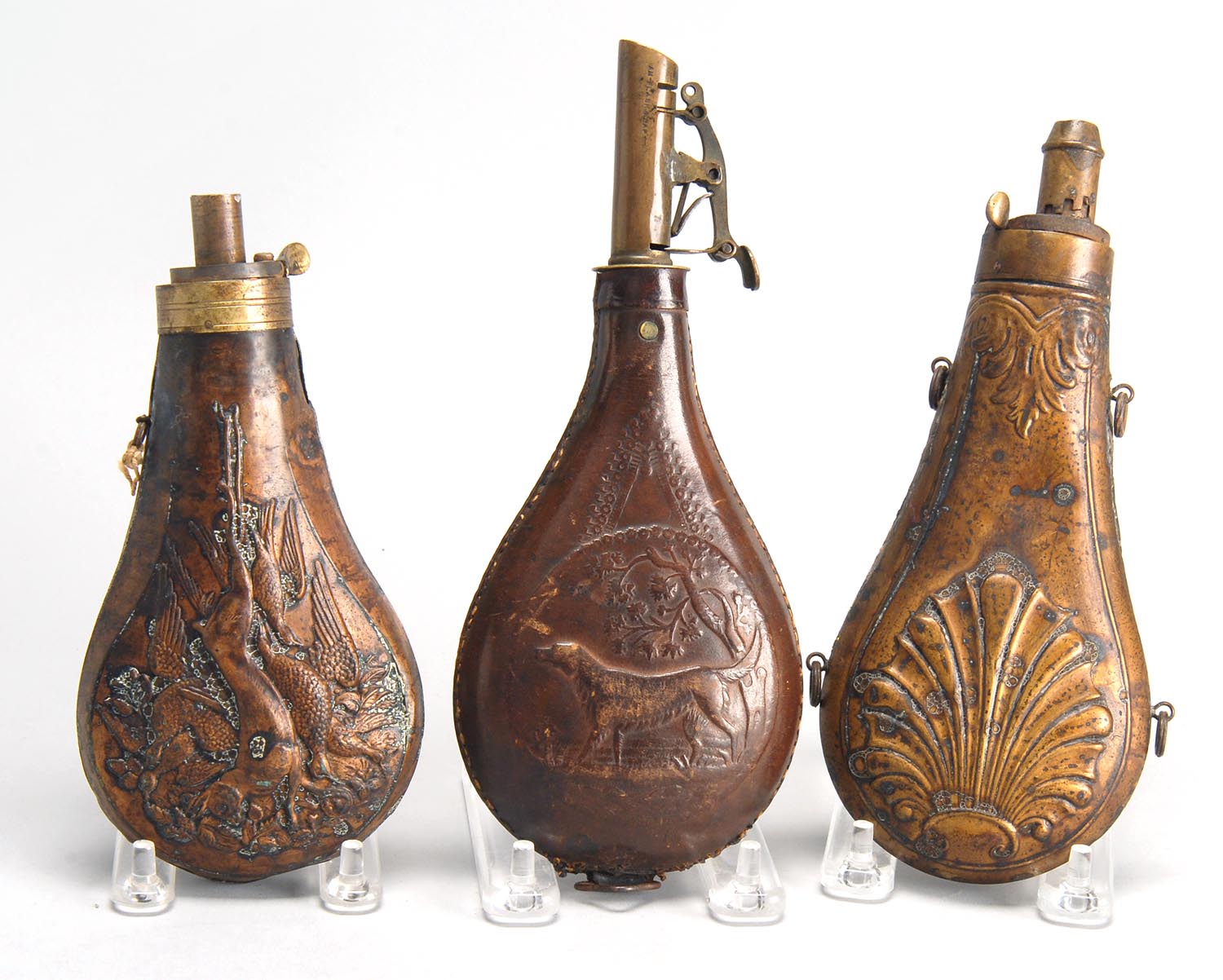 Appraisal: THREE POWDER FLASKS th CenturyTwo copper flasks and one leather