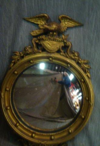 Appraisal: Antique Giltwood Convex Mirror with Eagle Top From a Southampton