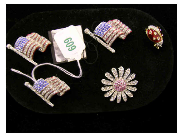 Appraisal: Five Swarovski brooches including three American flag motif one lady