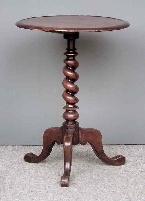 Appraisal: A Victorian mahogany circular tripod table the top with low