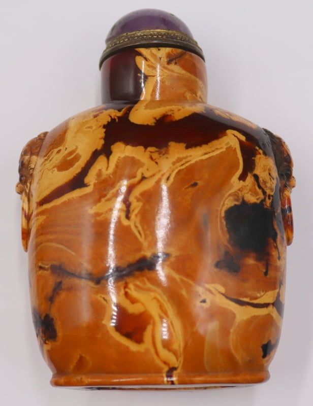 Appraisal: ANTIQUE CHINESE CARVED AMBER SNUFF BOTTLE Antique Chinese carved amber