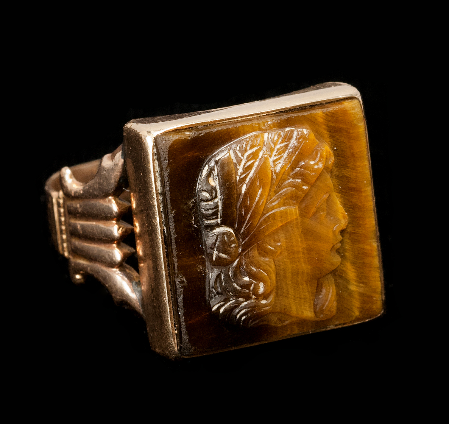 Appraisal: YELLOW GOLD AND CAMEO-CARVED TIGER'S-EYE RING With depiction of a