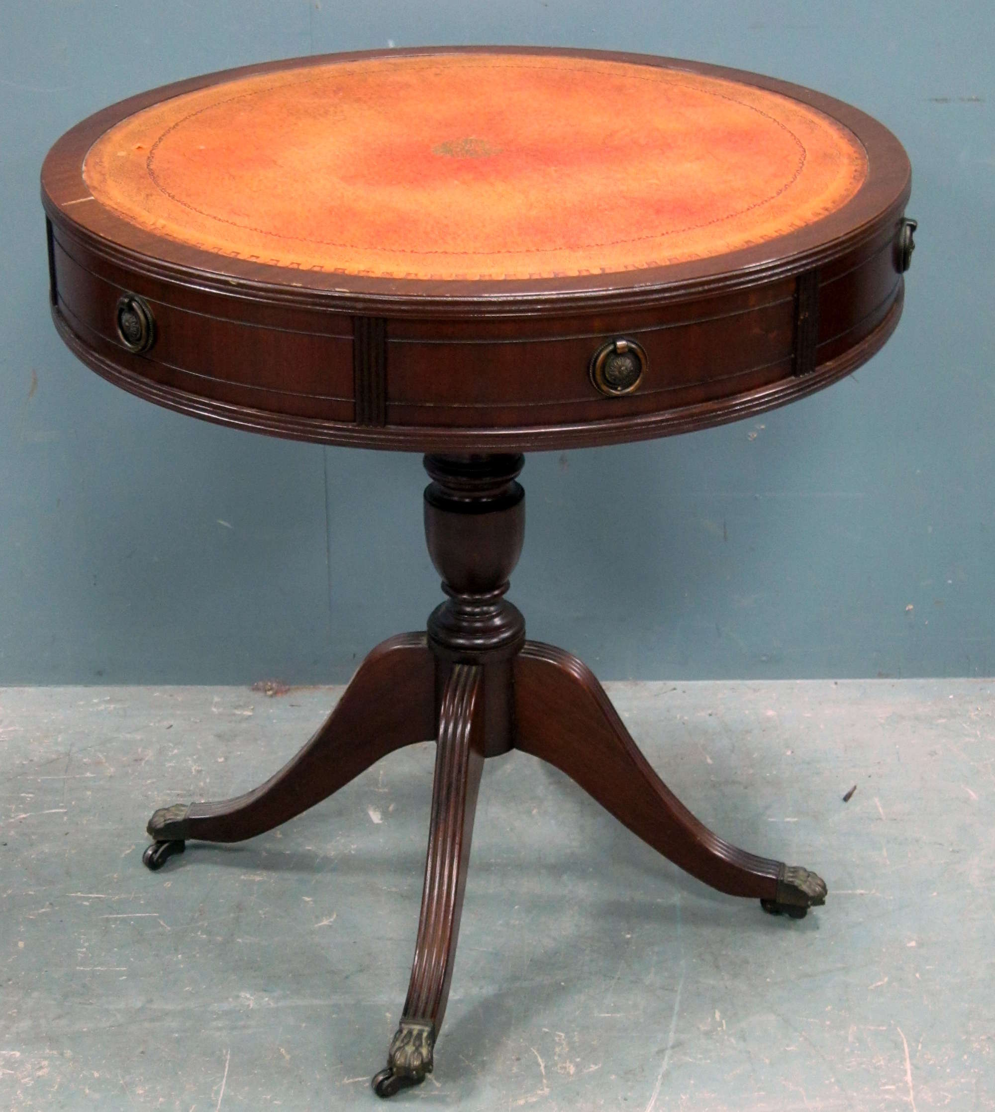 Appraisal: Mahogany reproduction drum table with red leather top on column