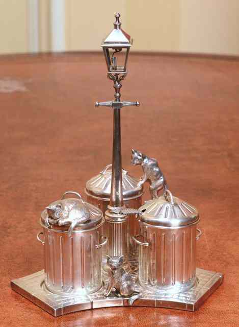 Appraisal: A SILVER CRUET SET in the form of cats at