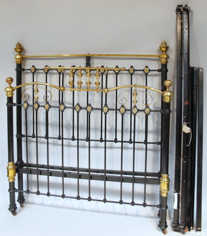 Appraisal: A metal framed double bed with cylindrical posts with mother