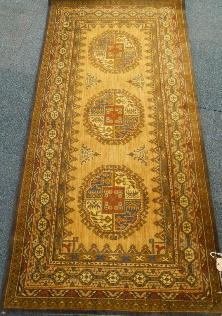 Appraisal: An English Caucasian style wool rug decorated with geometric motifs