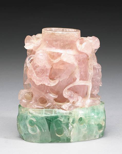 Appraisal: A carved rose quartz vase and green fluorite stand The