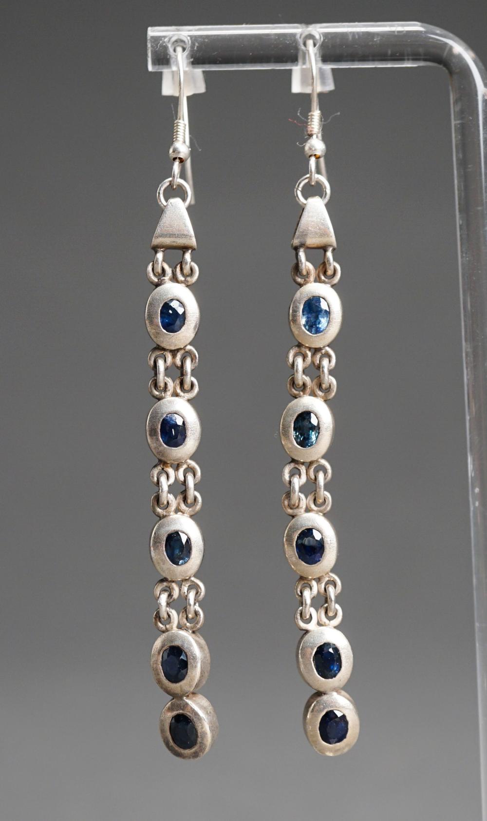 Appraisal: PAIR SILVER AND BLUE SAPPHIRE PIERCED PENDANT EARRINGS L IN