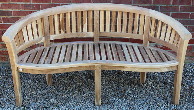 Appraisal: A TEAK GARDEN SEAT with slatted rounded back and slatted