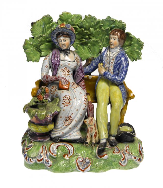 Appraisal: A STAFFORDSHIRE PEARLWARE 'PERSWASION' GROUP the lovers seated on an