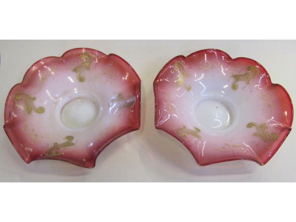 Appraisal: Pair of cranberry and opaque glass bowl with gilt decoration