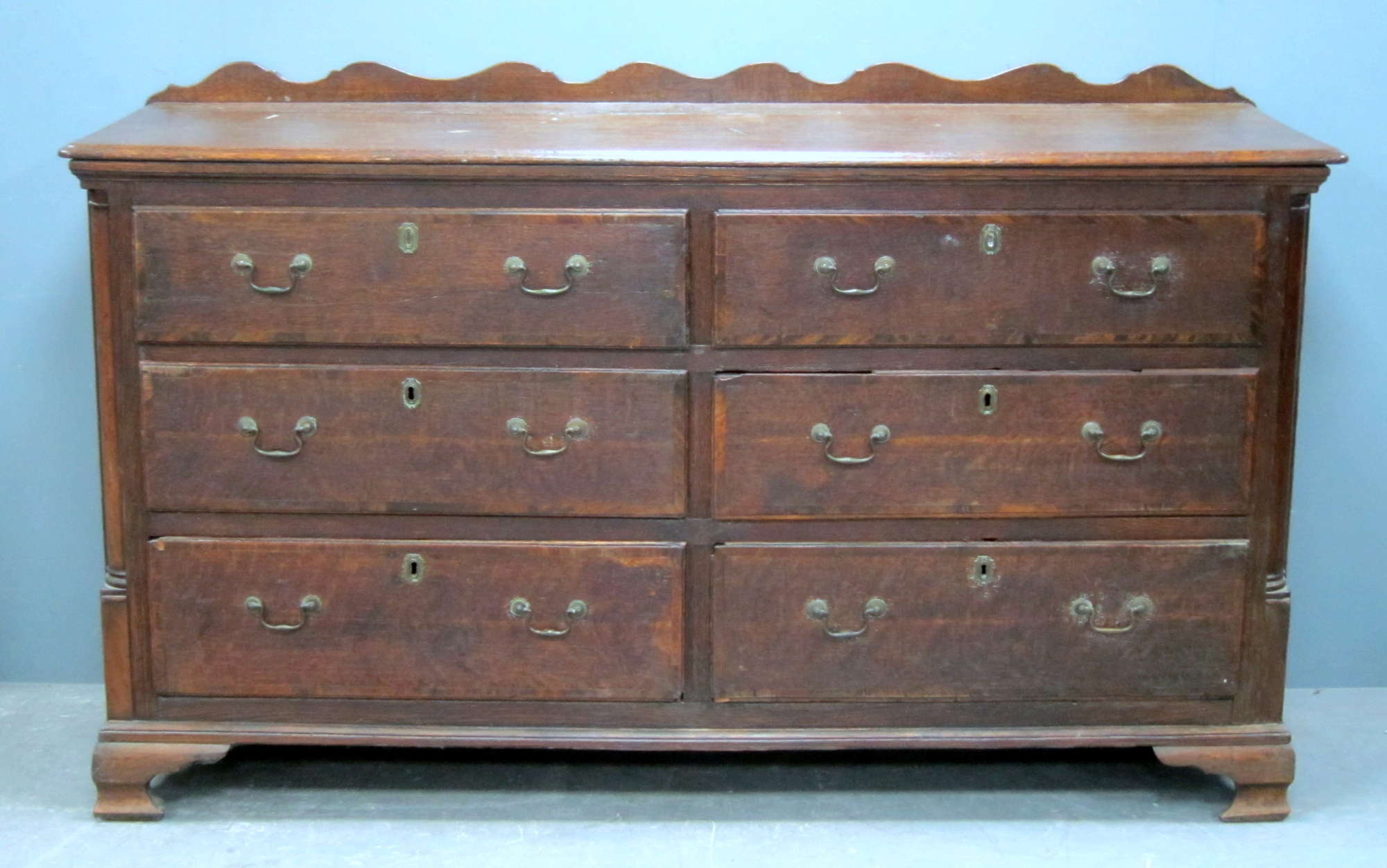 Appraisal: Oak merchants chest of six drawers on ogee bracket feet