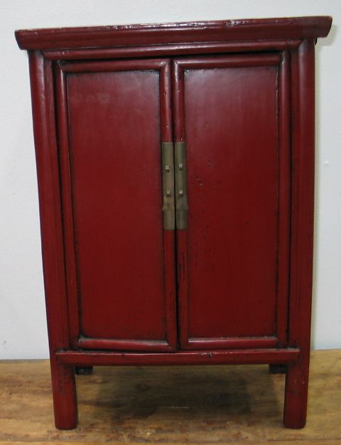 Appraisal: A small Chinese red lacquer cabinet with two doors and