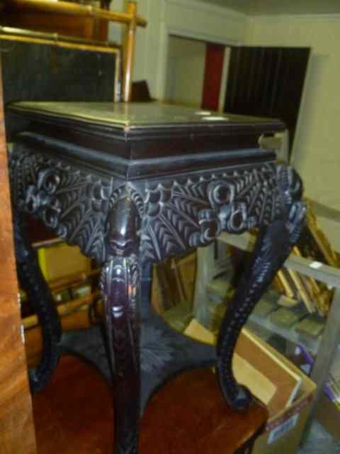 Appraisal: A CHINESE STYLE EBONISED SQUARE TOP URN STAND on carved