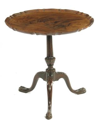 Appraisal: A mahogany low tripod table the pie crust edge top