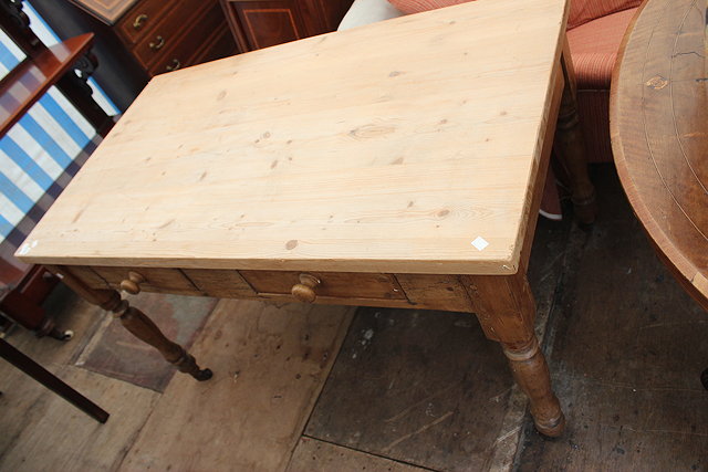 Appraisal: AN OLD PINE KITCHEN TABLE the scrubbed top over two