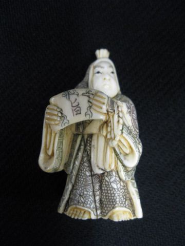 Appraisal: Carved Ivory Netsuke of a Robed Man holding a scroll