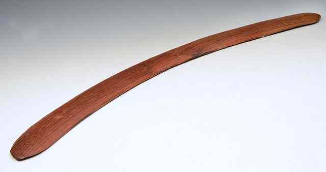 Appraisal: AN ABORIGINAL BOOMERANG with carved ribbed patination and ochre finish