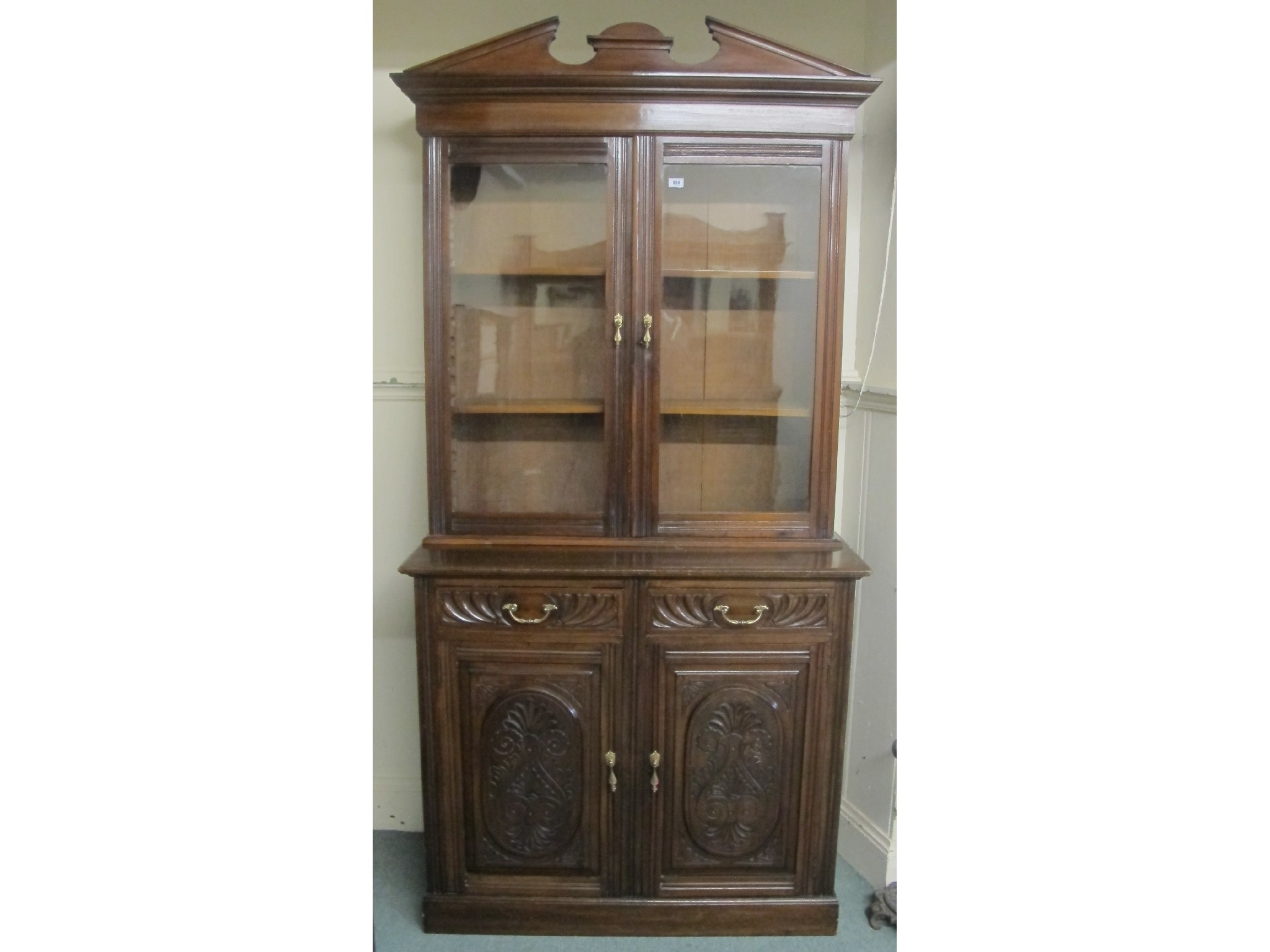 Appraisal: A Victorian mahogany bookcase with floral carved doors