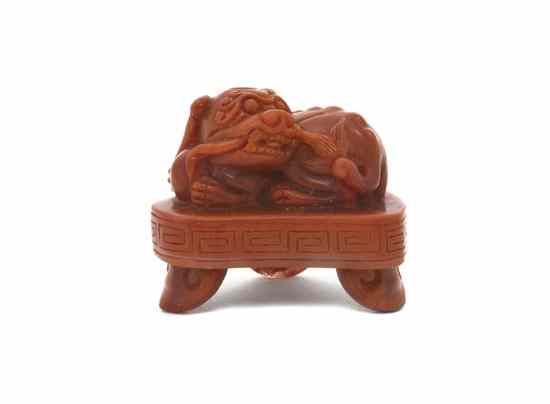 Appraisal: A Nanhong Agate Carved Lion the beast depicted in a