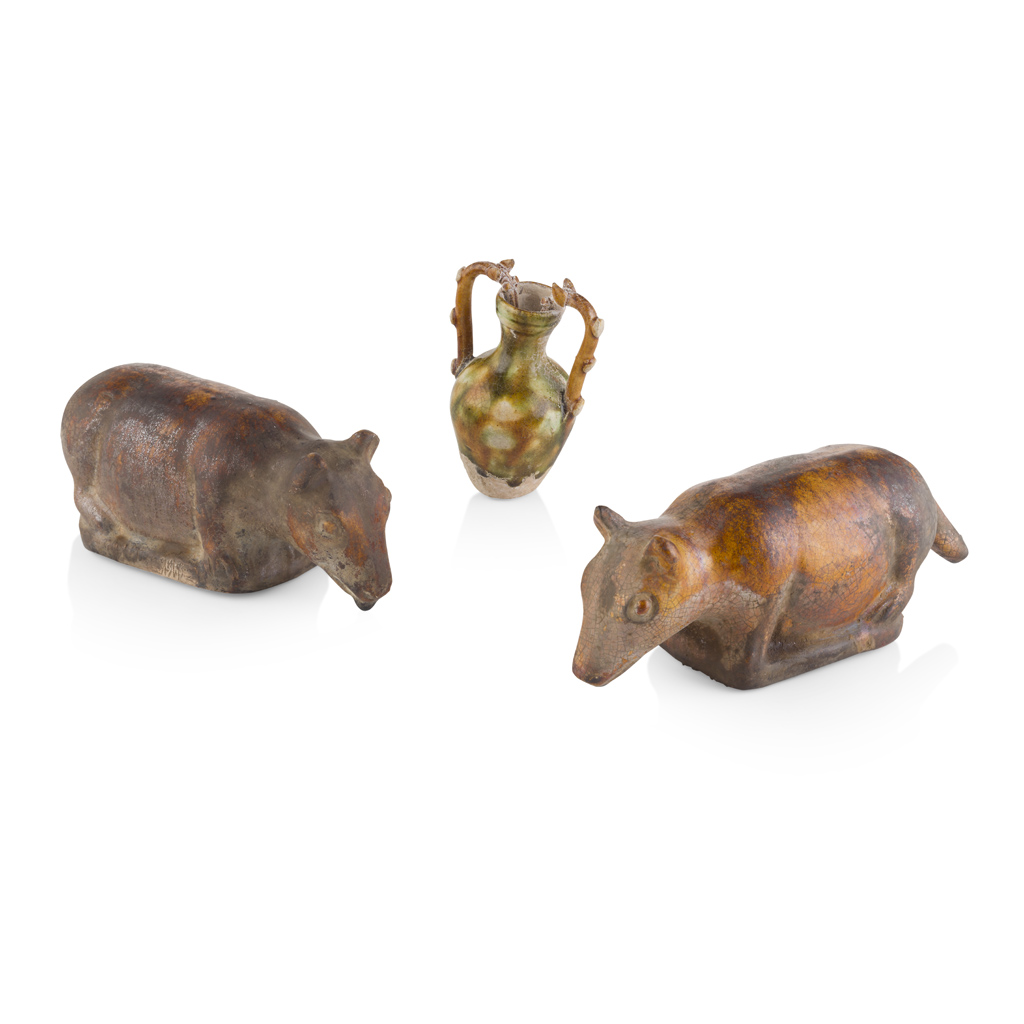 Appraisal: PAIR OF POTTERY BEARS the animal shown recumbent with head