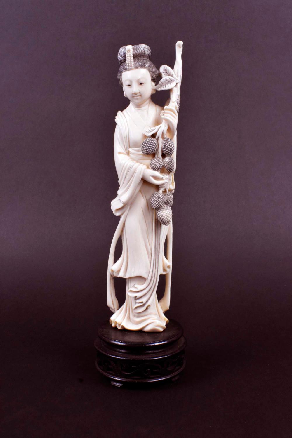 Appraisal: CHINESE CARVED FIGURE OF A MAIDENThe beauty holding a pine